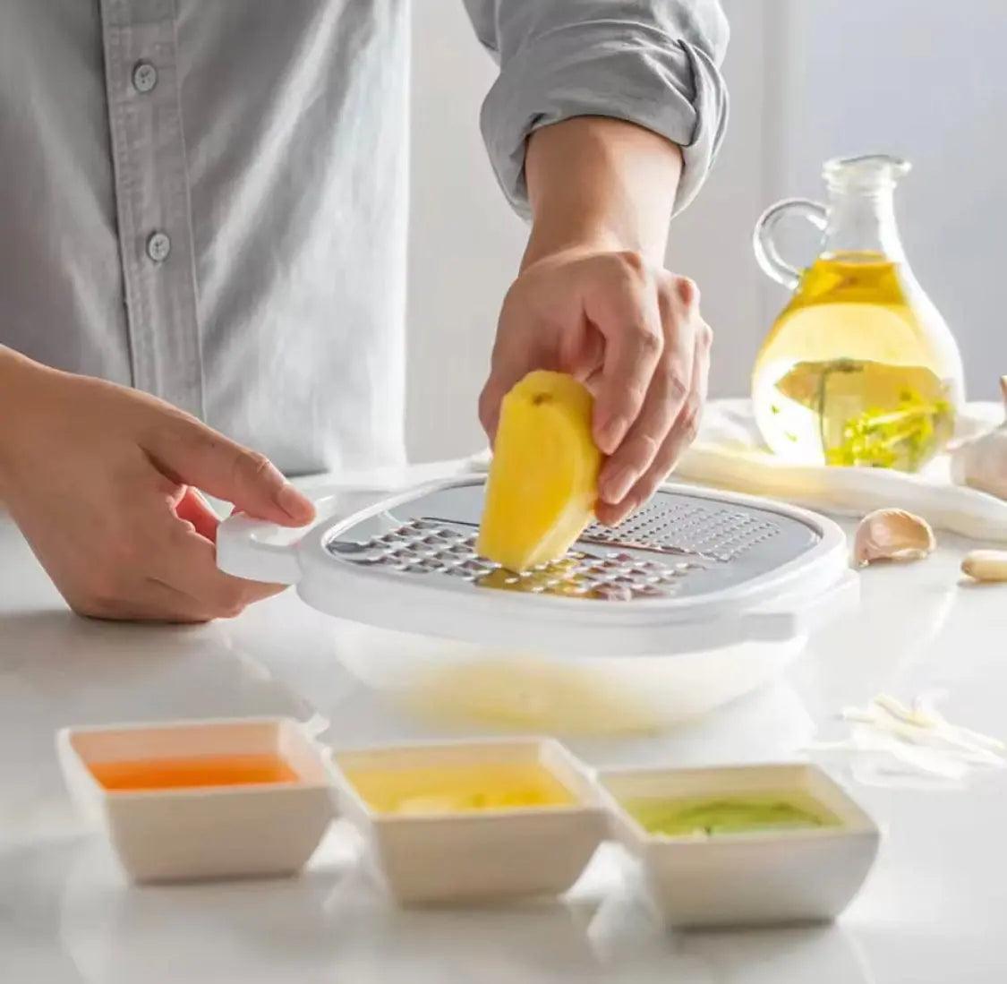 Person grating a yellow vegetable on a multi-function kitchen grater positioned over a white storage bowl.