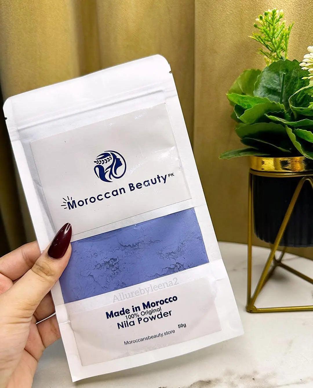 Hand holding a pouch of Moroccan Nila Blue Powder 50g natural clay face hair and body mask