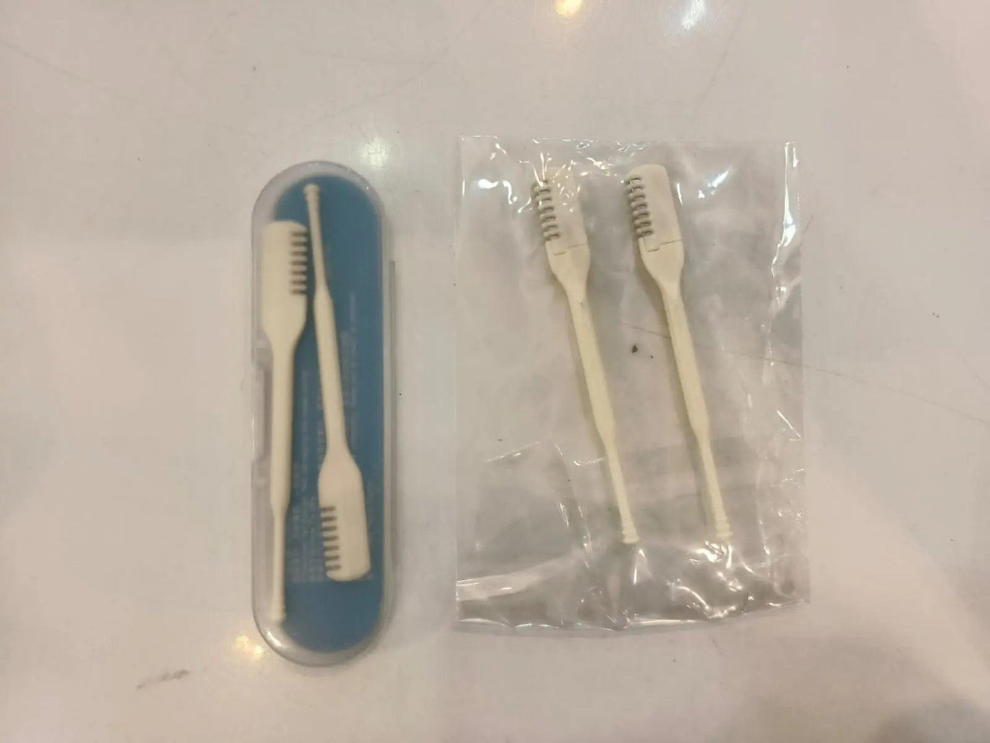 Manual nose hair razor in a protective case with two additional grooming and cleaning tools.