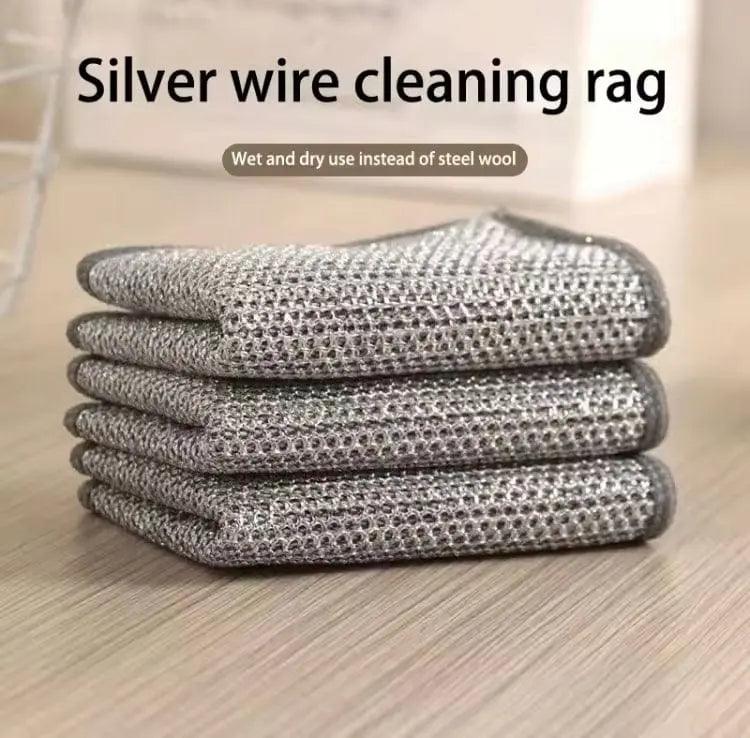 Reusable stainless steel mesh wire cleaning cloths cleaning pots, pans, sinks, and kitchen surfaces effectively.