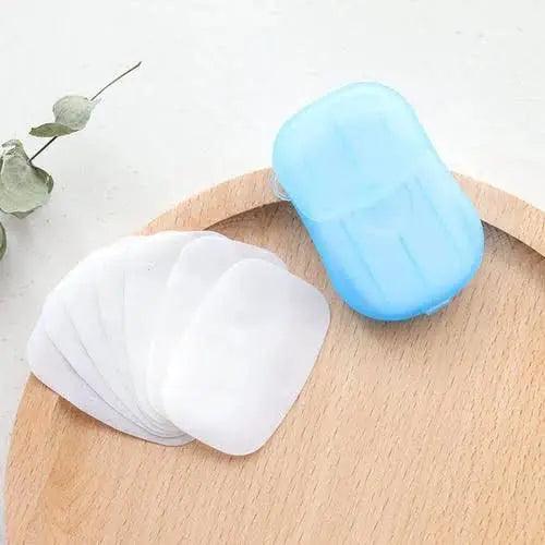 White portable hand-washing soap sheets displayed beside a compact blue travel case.